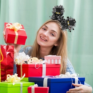 Detail of 2026 New Year headband with mini top hats and stars worn in a party setting