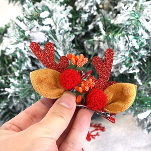Cute Christmas reindeer antler hair clips with glitter ears and red berries detail
