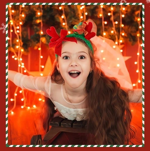 Close-up of a festive plush reindeer antler headband worn by a child in Christmas setting