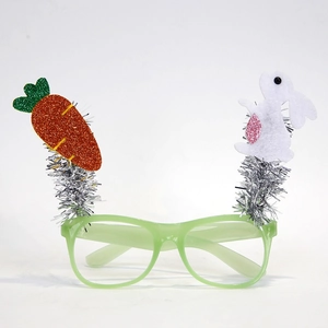 Detail of Easter party glasses with silver glitter, fabric bunny and carrot decorations