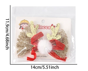 Détail de la pince à cheveux bois de renne pailletés avec nœud rouge et pompon