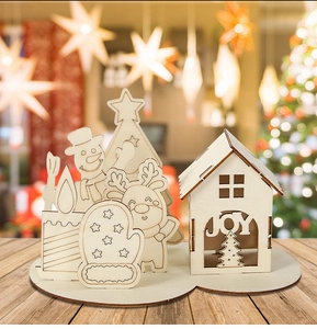 Detailed view of DIY wooden Christmas cabin set with JOY cutout and festive elk figures