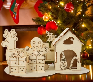 Detail of laser-cut wooden Christmas puzzle house with reindeer and gingerbread man