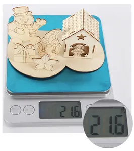 Detailed view of lightweight Christmas wooden puzzle pieces weighing 21.6g on a digital scale