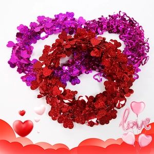 Sparkly heart tinsel garland in red and purple for Valentine wedding party decoration