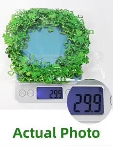 Close-up of green shamrock garland decoration on a scale weighing 29.9 grams