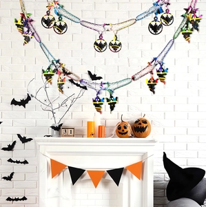 Close-up of Halloween ghost and bat garland decorations on a white fireplace mantle