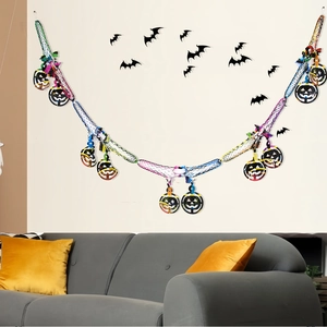 Detailed view of Halloween honeycomb garland featuring hanging black pumpkin pendants
