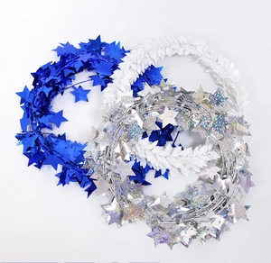 Close-up of blue, white, and holographic silver star tinsel garlands for holiday decor