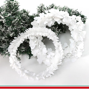 Detail view of white decorative heart and leaf garlands for festive DIY wreath making