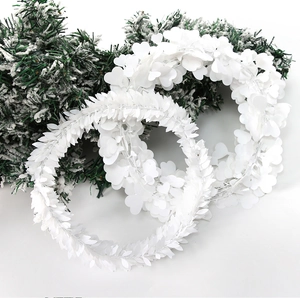 Detail of white artificial vine leaves with heart and feather shapes for DIY wreaths