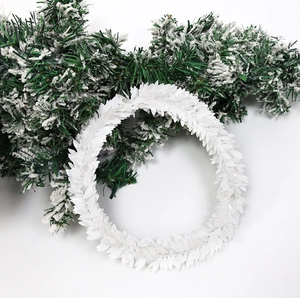 Macro detail of artificial white leaf garland with festive winter decorative elements