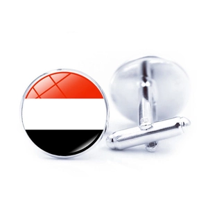 Detailed view of silver-tone round cufflinks with Yemen flag colors and polished glass dome