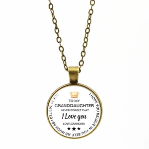 Macro view of vintage bronze granddaughter necklace with inspirational crown message