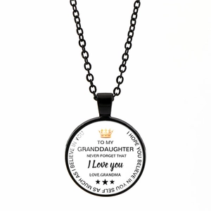 Detail of granddaughter heart necklace with crown logo and inspiring printed quote
