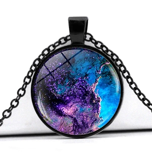 Detailed close-up of a round cosmic nebula pendant featuring blue and purple galaxy artwork