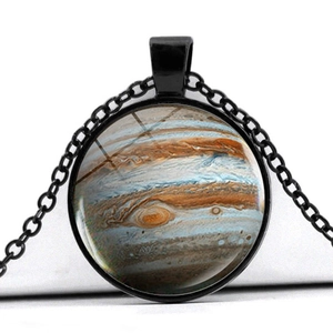 Detailed macro view of Jupiter nebula glass pendant with black metal circular frame