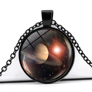Macro shot of solar system nebula pendant necklace with Saturn pattern and glass dome