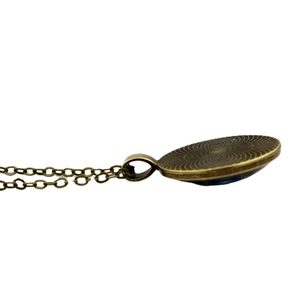 Retro bronze galaxy pendant necklace with concentric circular patterns on back