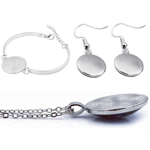 Silver autism awareness jewelry set with round tray pendants for DIY crafting projects