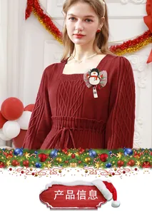 Detailed view of snowman retractable badge reel with sequins on a red knit sweater