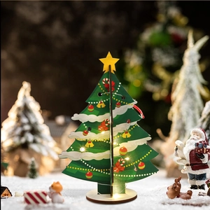 Detail of DIY green wooden Christmas tree with warm LED lights on a snowy background