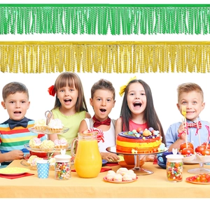 Detail of shiny green and gold tinsel fringe banners for birthday party wall decoration