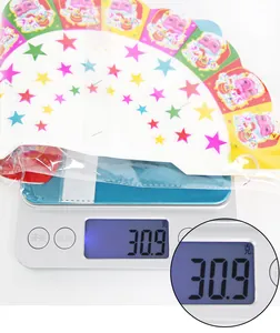 Detailed view of Merry Christmas paper hanging decoration weighing 30.9g on digital scale