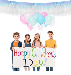 Close-up of colorful iridescent tinsel garland with macaron balloons for kids party decor