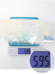 Macro view of iridescent tinsel curtain weight measurement on a blue digital scale