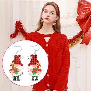 Close-up of festive Christmas gnome earrings with red buffalo plaid hat and glitter detail