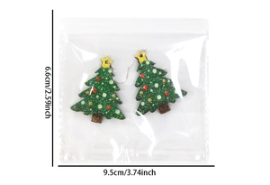 Detail view of sparkling green Christmas tree earrings with colorful balls and hooks