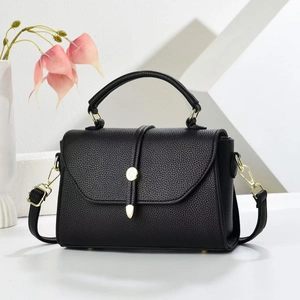 Classic black crossbody handbag for women with gold clasp and textured leather finish
