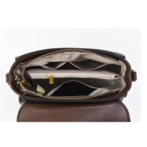 Top view of multi-compartment interior for solid color crossbody bag with beige lining