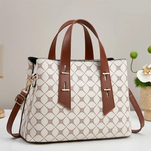 Chic white monogram tote bag with brown handles and adjustable crossbody strap