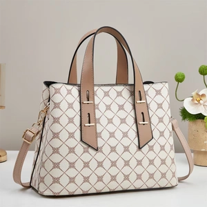 Elegant white geometric patterned tote bag with brown leather handles and shoulder strap
