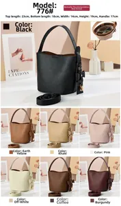 Litchi pattern bucket bag details showing side bow decoration and golden lock hardware