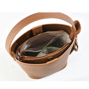 Internal view of brown pebble leather bucket bag with a zippered inner liner