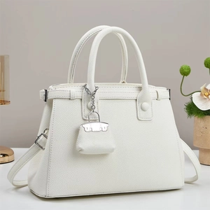 Elegant white lychee grain leather handbag with top handles and a mini charm pendant