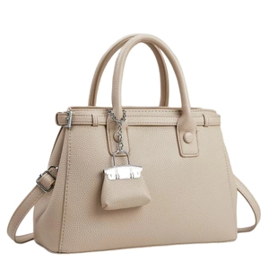 Elegant beige lychee grain leather handbag with top handles and detachable shoulder strap