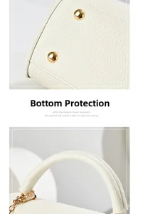 Close-up of white lychee leather handbag featuring protective gold bottom rivets and handles