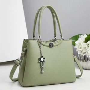 Light green lychee texture tote bag with floral pendant and adjustable crossbody strap