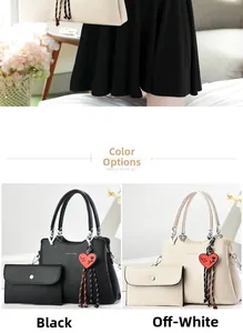 Detail view of large tote bags in black and cream with matching clutch and heart pendant