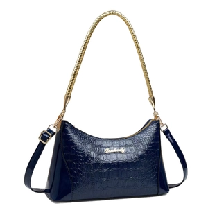 Navy blue crocodile pattern tote bag with gold metal handle and logo on white background
