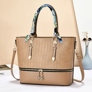 Brown woven leather tote bag with silk scarf handle and golden flower charms