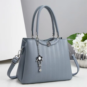 Gray blue large capacity handbag with textured leather and floral metal pendant detail