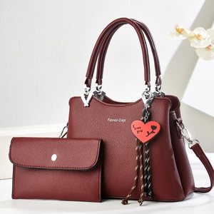 Deep red pebbled leather tote bag set with matching wallet and heart pendant