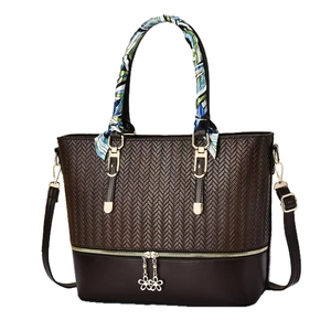 Deep brown tote bag with woven texture, decorative silk scarf and flower charm