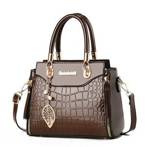 Dark brown faux crocodile leather handbag with glossy finish and gold metal accents