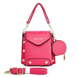 Fuchsia crossbody bag with crocodile texture, woven handle and round coin purse